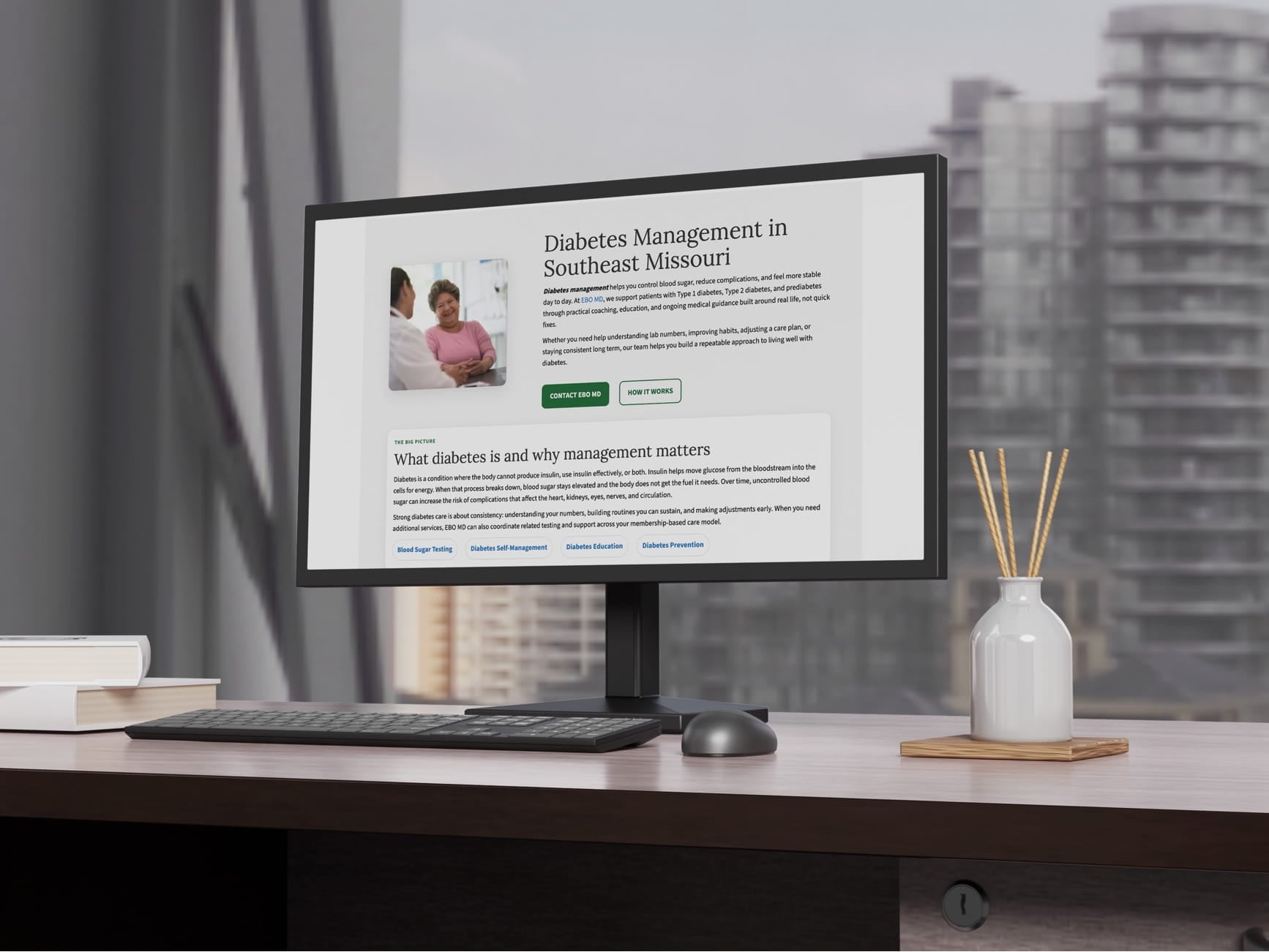 Monitor shows diabetes management website for Southeast Missouri with doctor‑patient photo and green buttons.