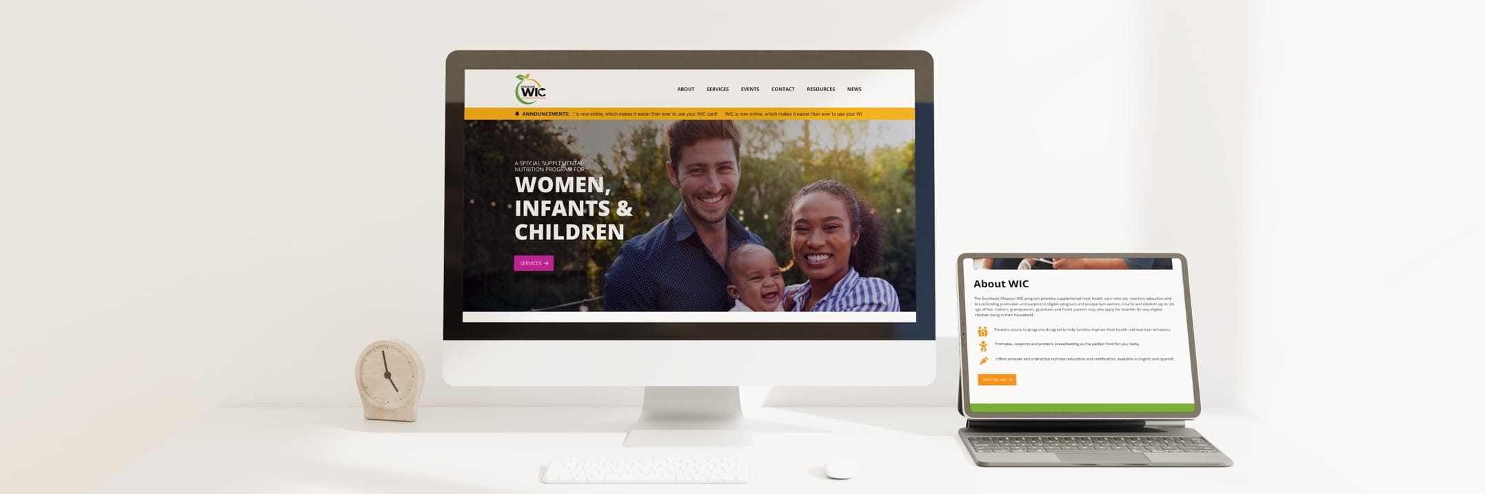 Desktop monitor shows WIC website with women, infants and children; laptop shows About WIC page; desk with clock.