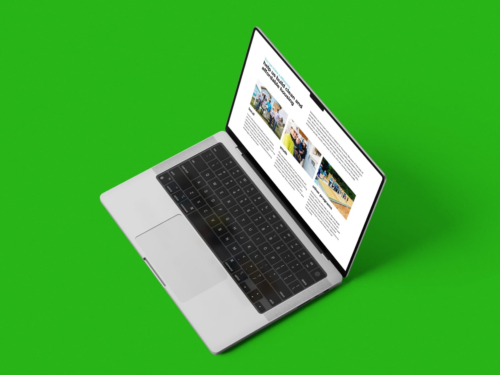 Laptop on green background showing a webpage about clean and affordable housing with local, youth, and other program sections