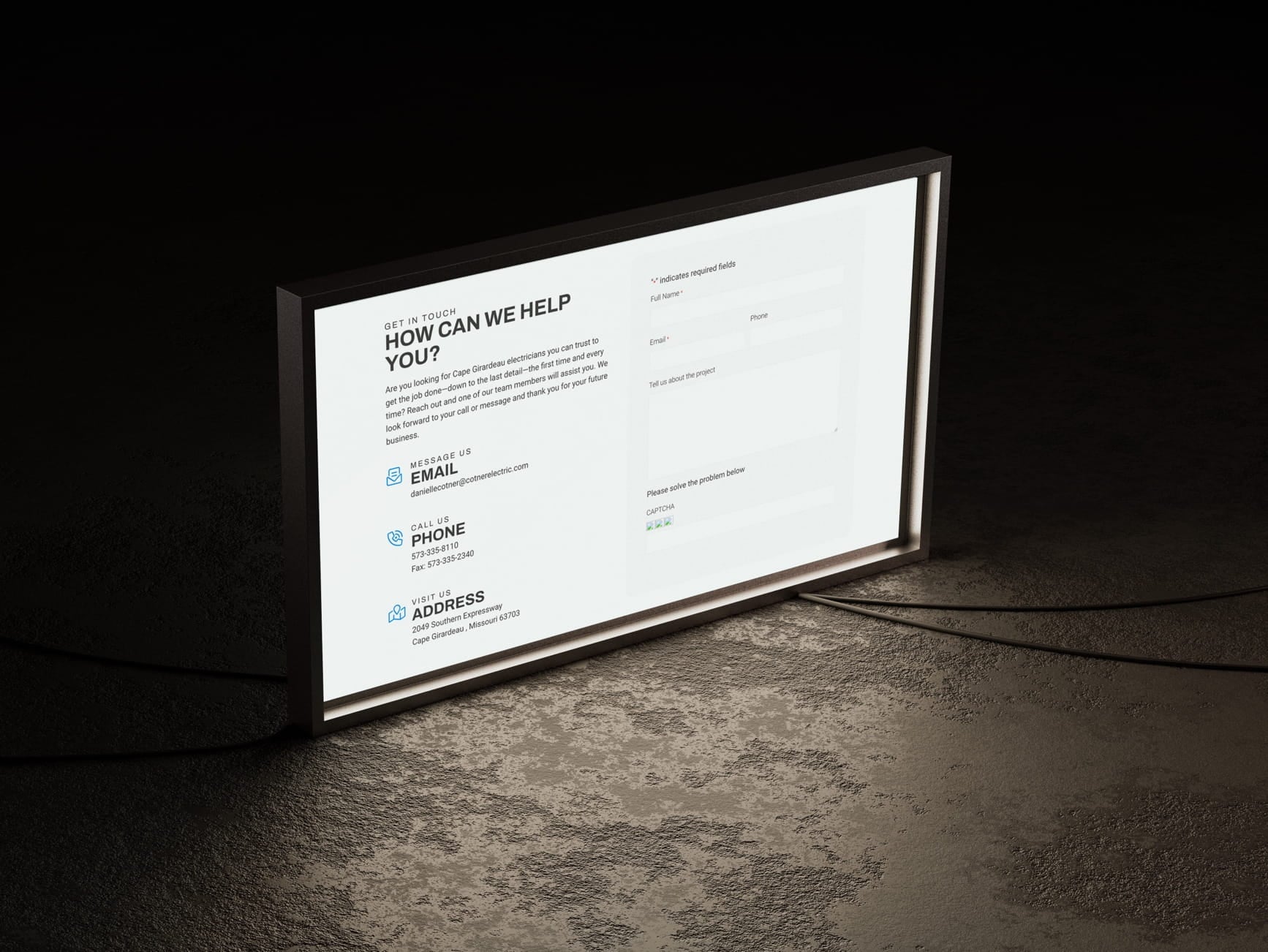 Lit signboard showing Cape Girardeau electrician contact info, email, phone, address, and a web form.