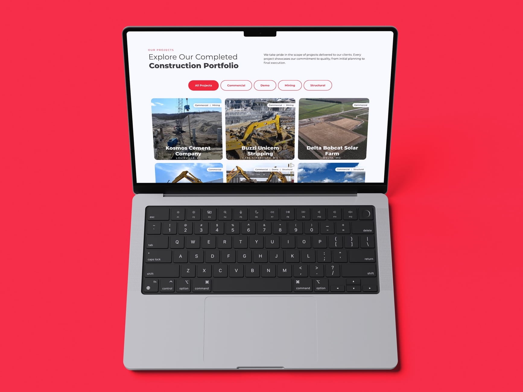 Laptop showing a construction portfolio webpage with project thumbnails and filter buttons on a red background.