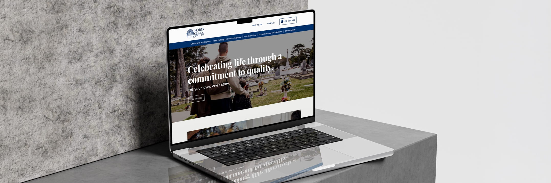 Laptop showing Ford Valley Monuments site with cemetery photo and slogan 'Celebrating life through a commitment to quality'.