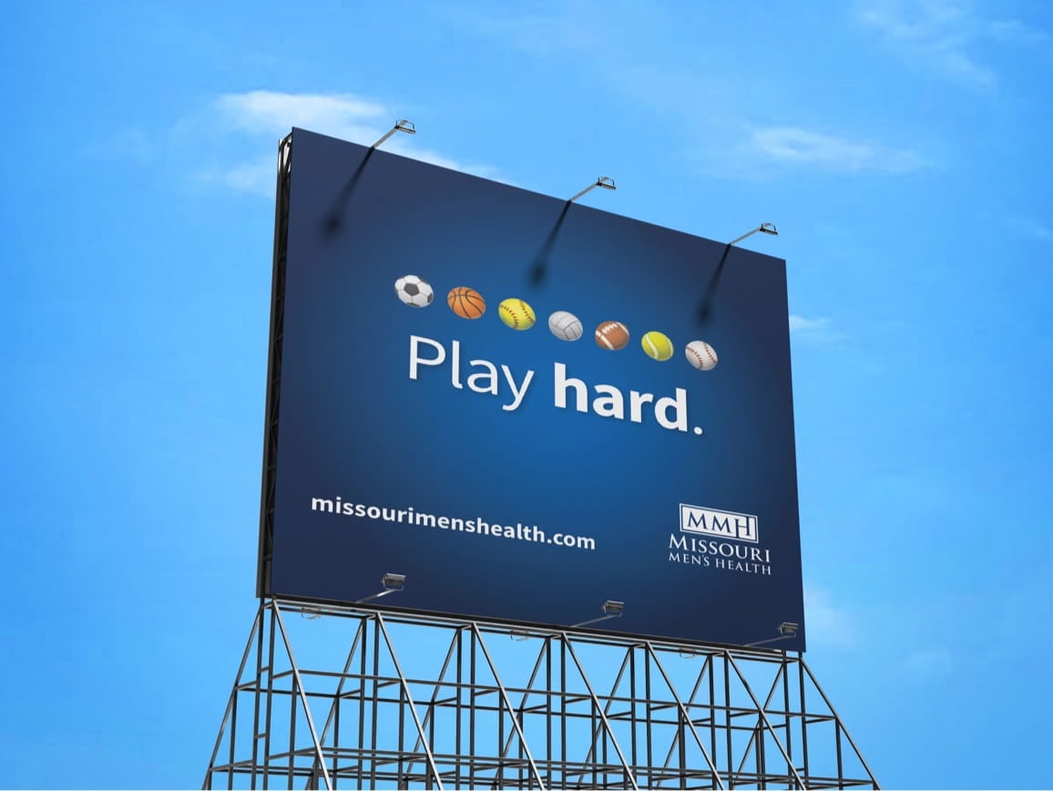 Blue billboard shows sports balls, slogan 'Play hard.', missourimenshealth.com and Missouri Men's Health logo.