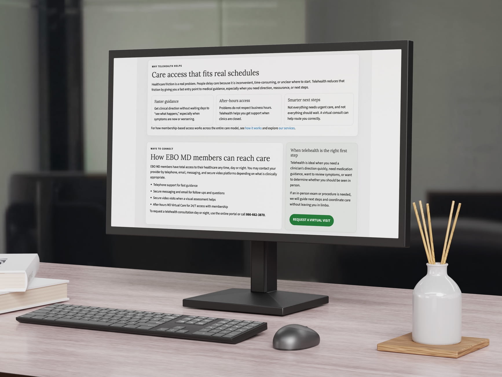 Monitor showing a telehealth webpage for EBO MD members, with keyboard, mouse, books, and a diffuser on a wooden desk.