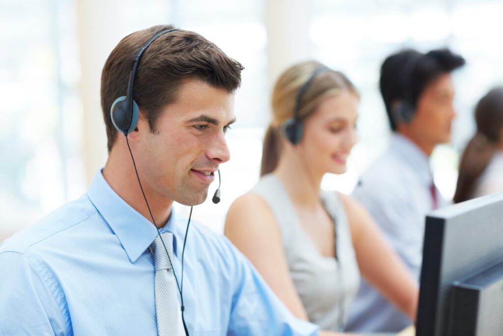 Cropped shot of telecommunications workers sitting at their desks