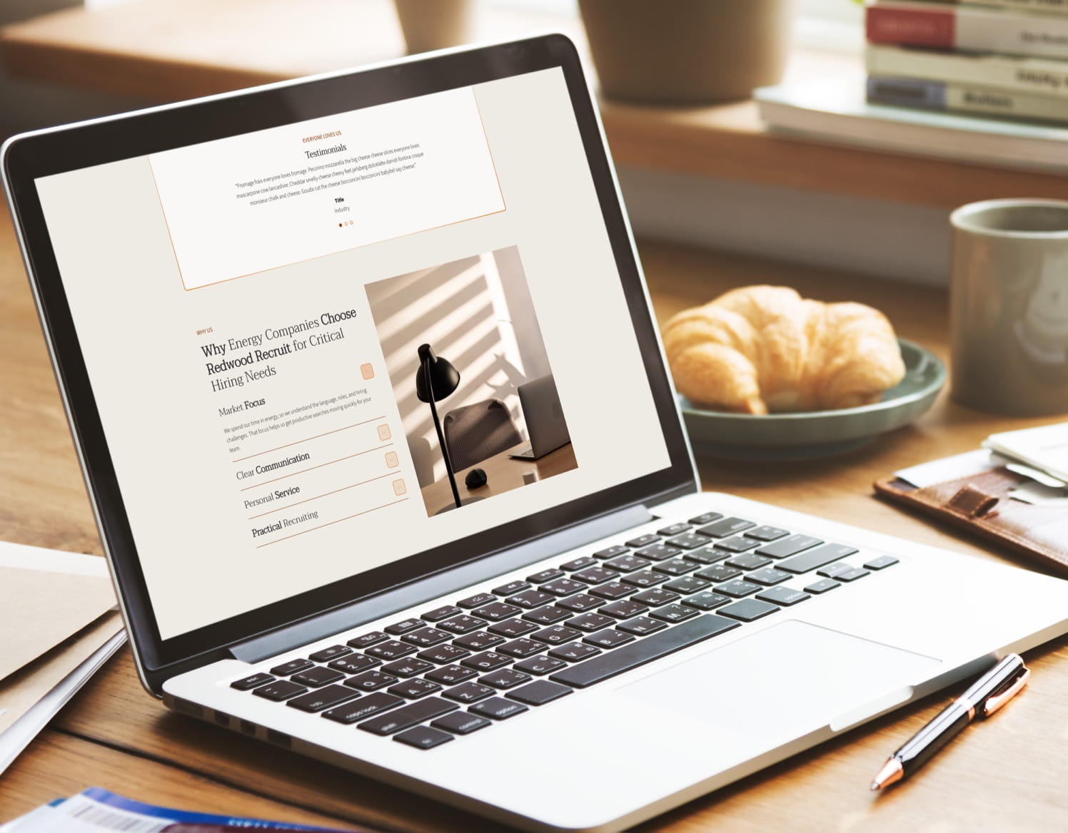 Laptop displaying a website about Redwood Recruit for energy companies, with testimonials and services.